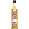 Back view of bottle of Bharat Vedica Organic Wood Pressed Flaxseed oil on a white background