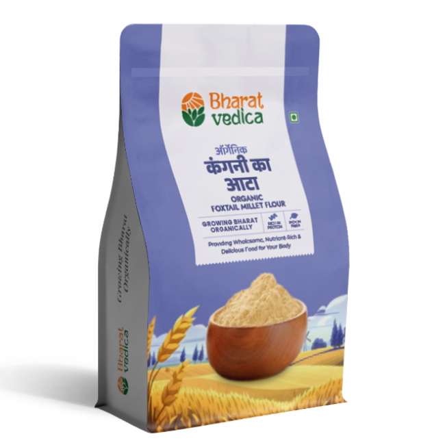 A blue and white packet of Bharat Vedica brand Organic Foxtail Millet Flour, with text in both Hindi and English. The packet features the brand logo at the top and an image of foxtail millet grains at the bottom. The text on the packet reads "ऑर्गेनिक कंगनी का आटा ORGANIC FOXTAIL MILLET FLOUR" and "Providing Wholesome, Nutrient-Rich & Delicious Food for Your Body".
