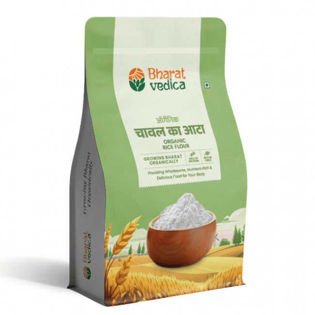 A green and white packet of Bharat Vedica brand Organic Rice Flour, with text in both Hindi and English. The packet features the brand logo at the top and an image of rice grains at the bottom. The text on the packet reads "ऑर्गेनिक चावल का आटा ORGANIC RICE FLOUR" and "Providing Wholesome, Nutrient-Rich & Delicious Food for Your Body".